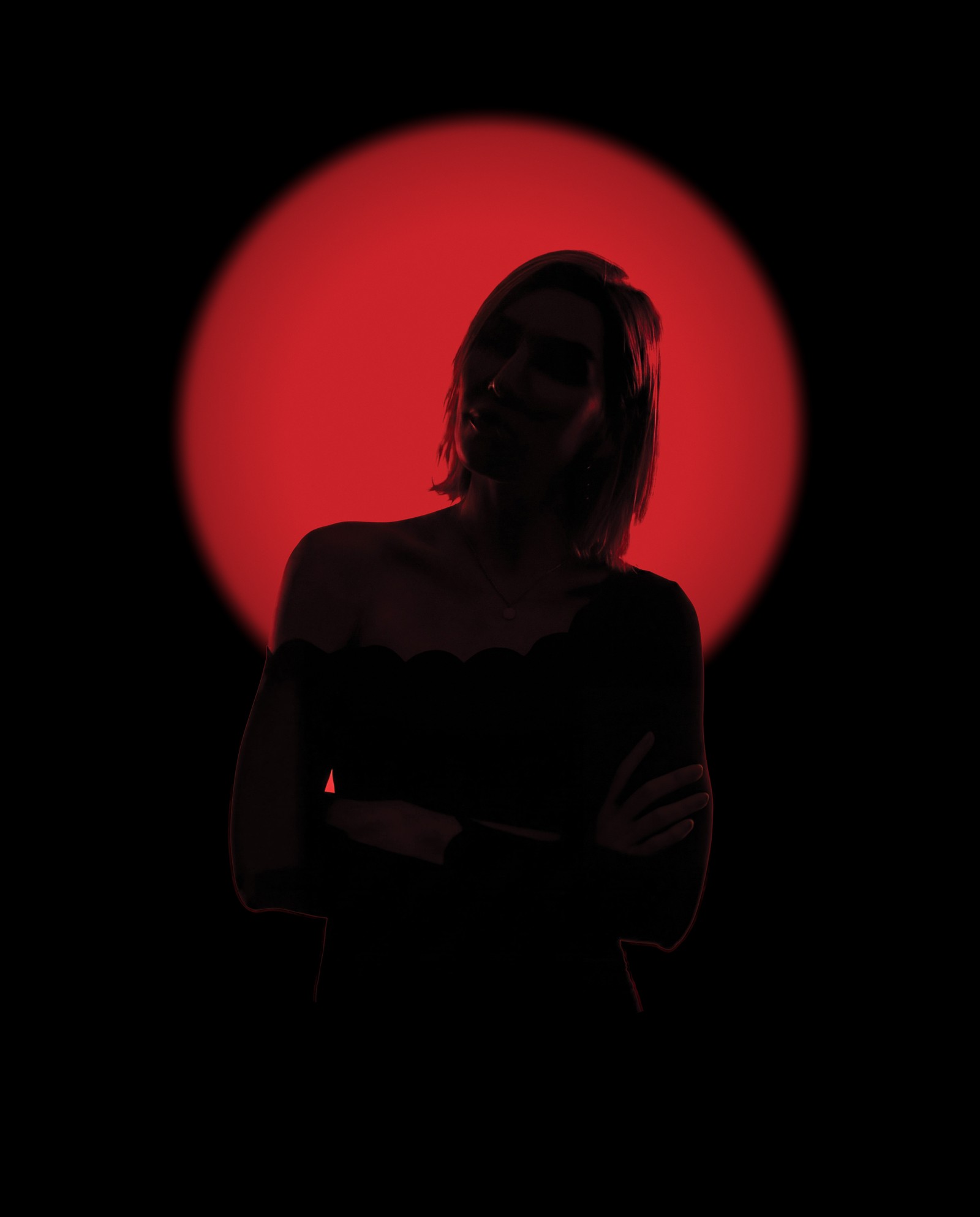 Nelly Ilyasova in silhouette against a deep red light